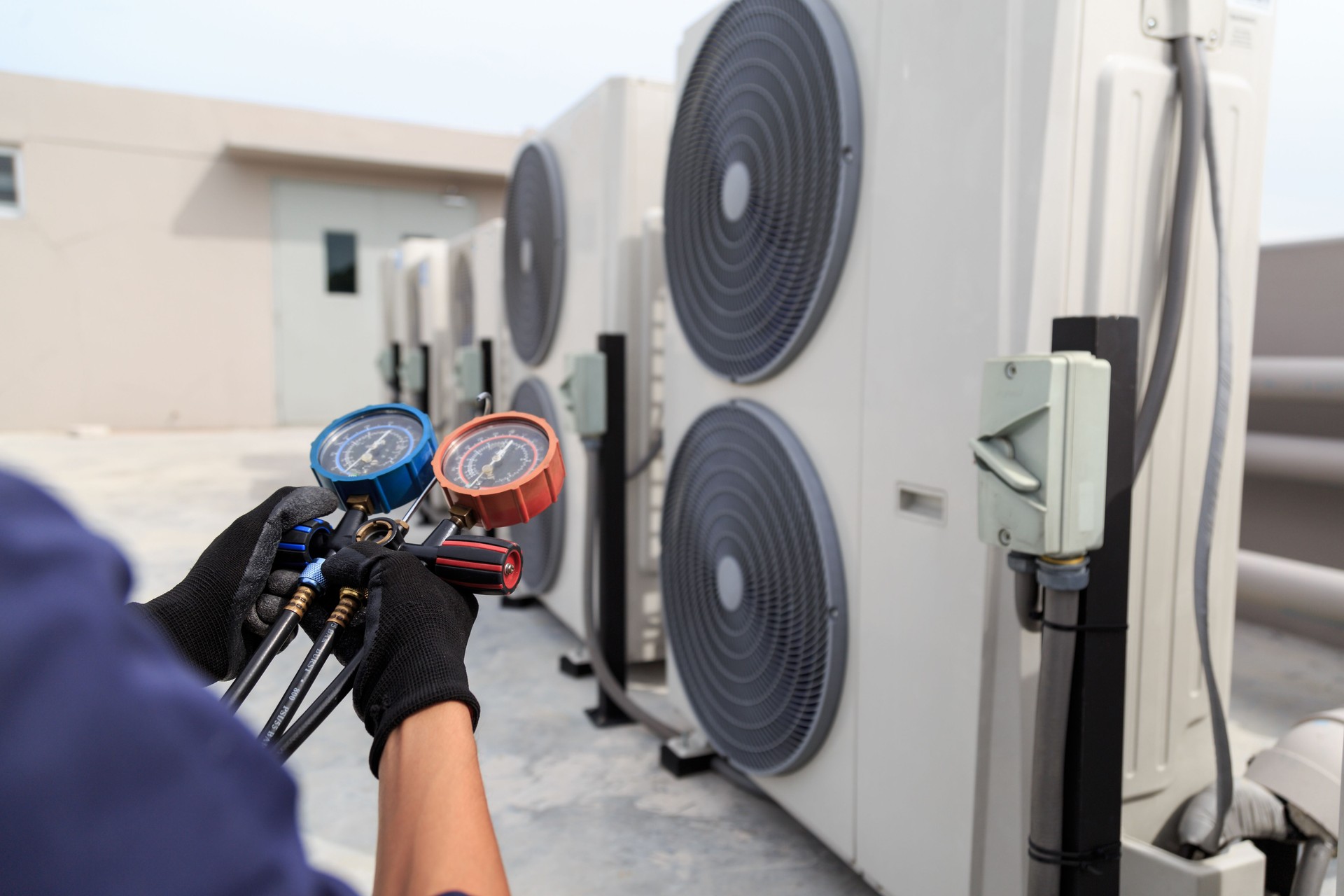 Technician is checking air conditioner ,measuring equipment for filling air conditioners.